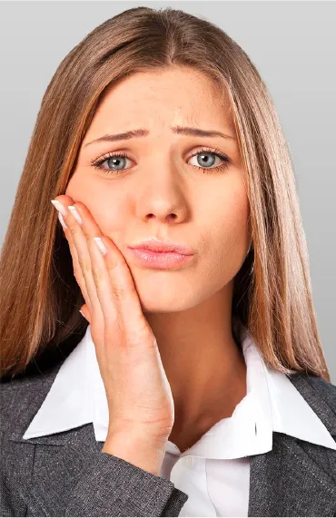 woman with tooth pain holding the side of her face