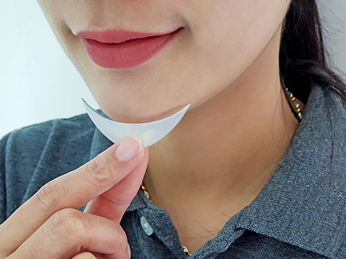 Woman holding a sample of a chin implant